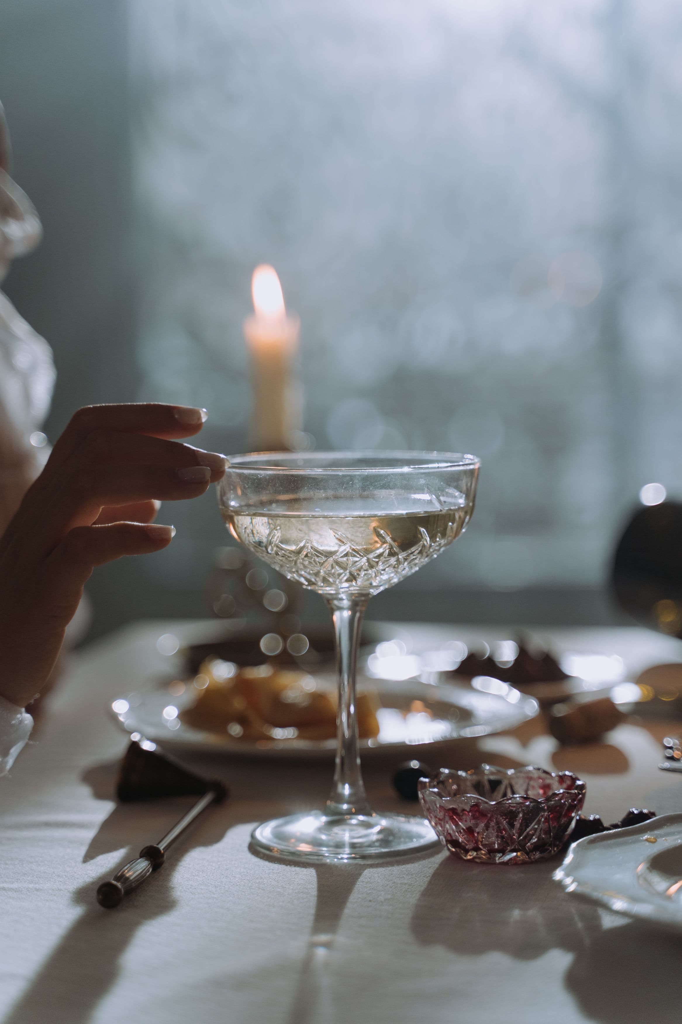 A lived-in dinner table with crystal glasses in ordinary daily use, not styled for a special occasion