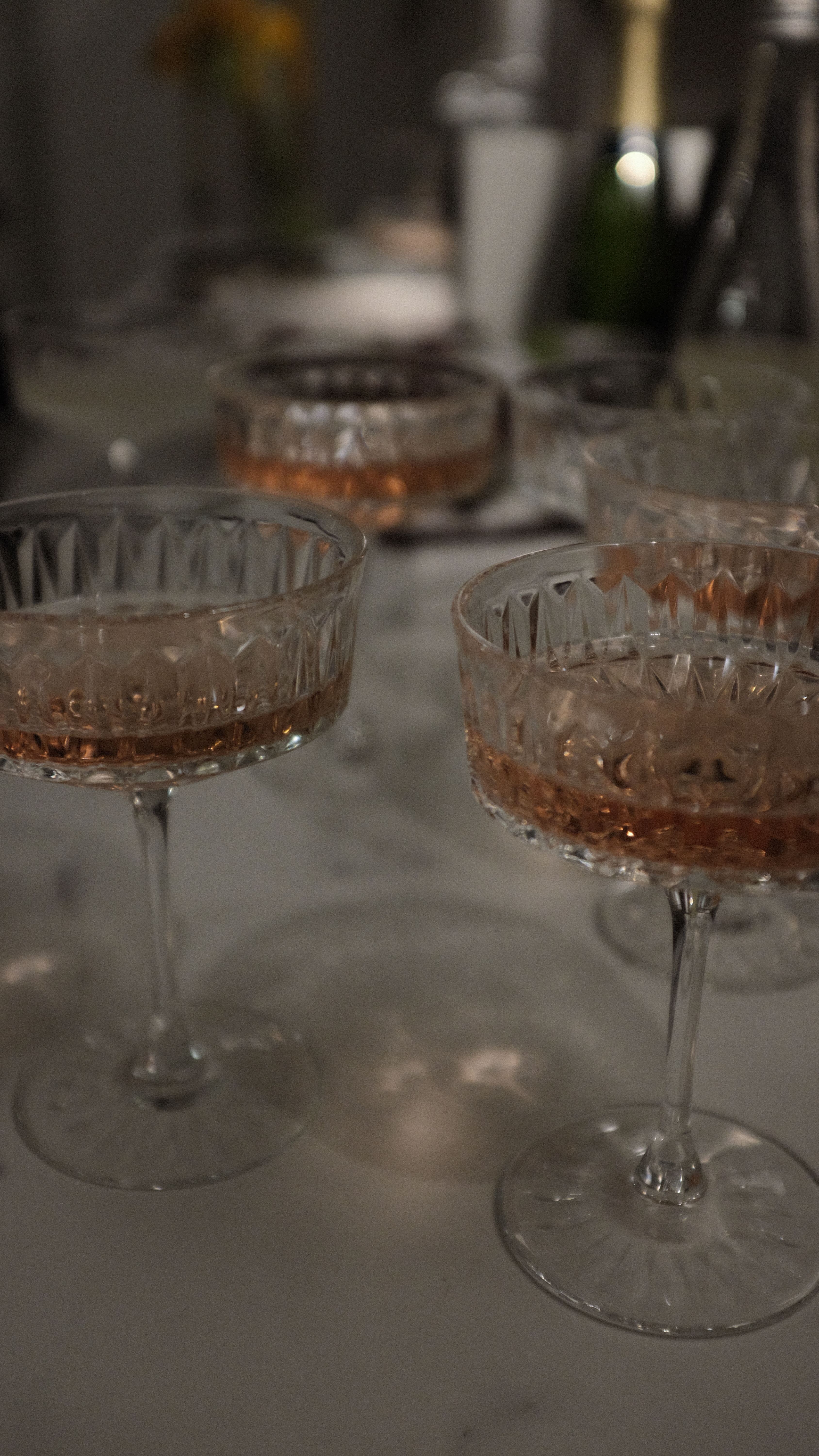 An everyday table set with fine crystal glasses in natural light, glasses that look used rather than staged for an occasion