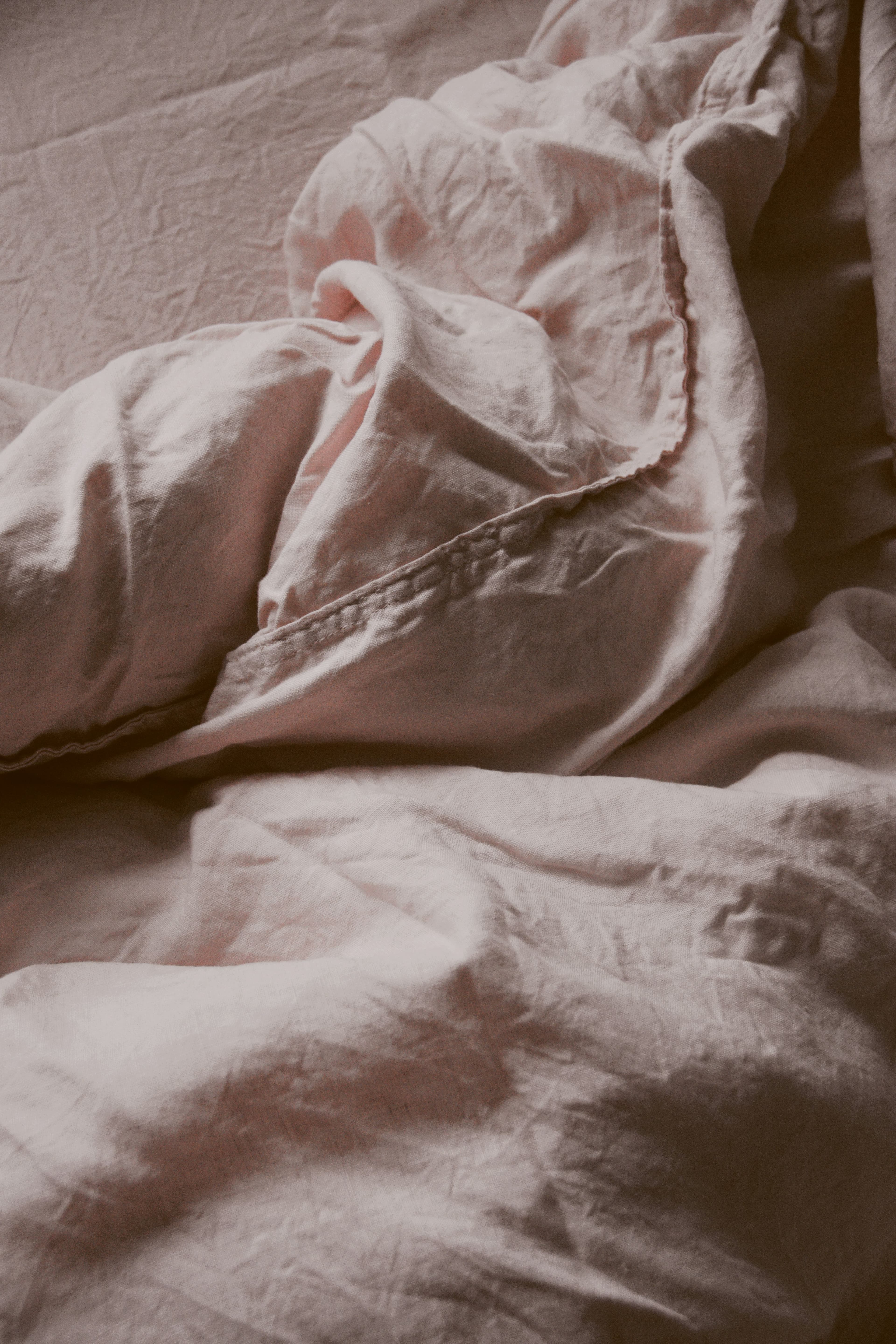 Folded linen sheets showing fabric weight and drape