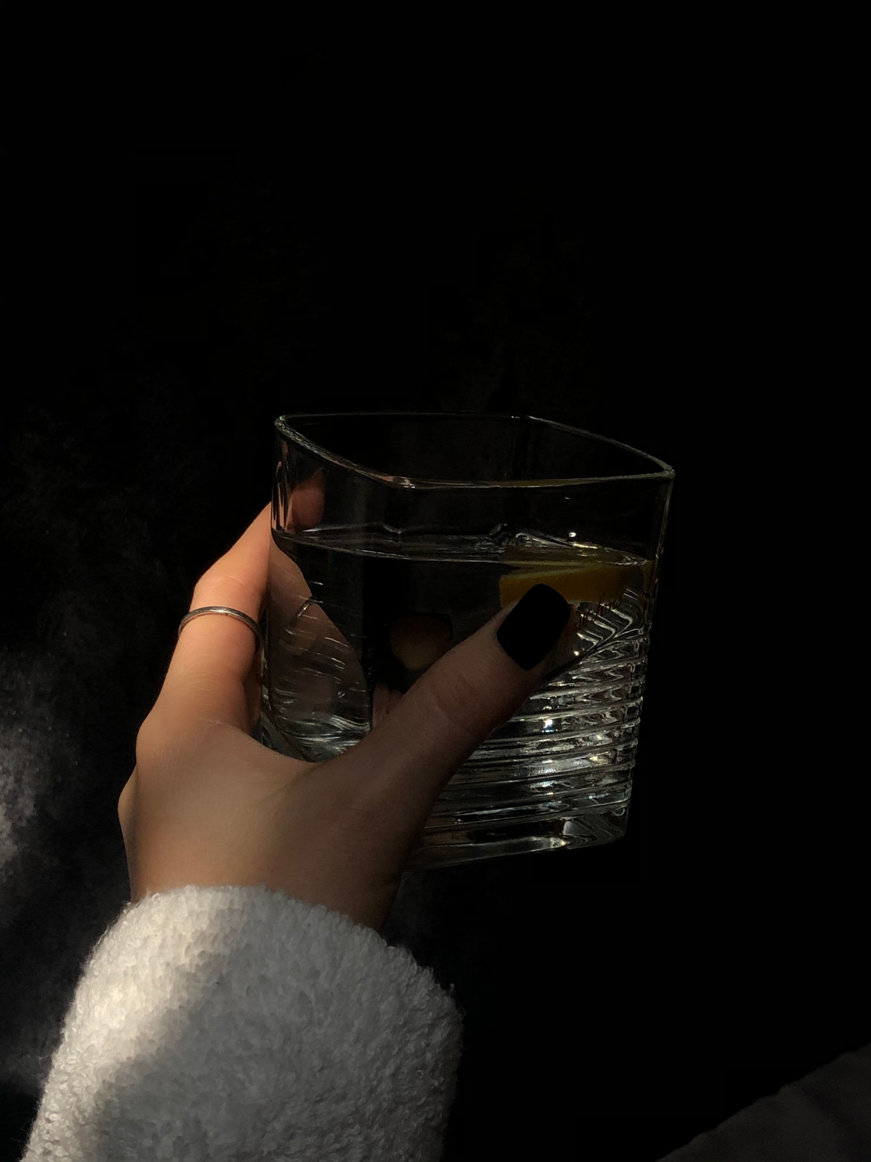 A water glass beside breakfast in ordinary morning light