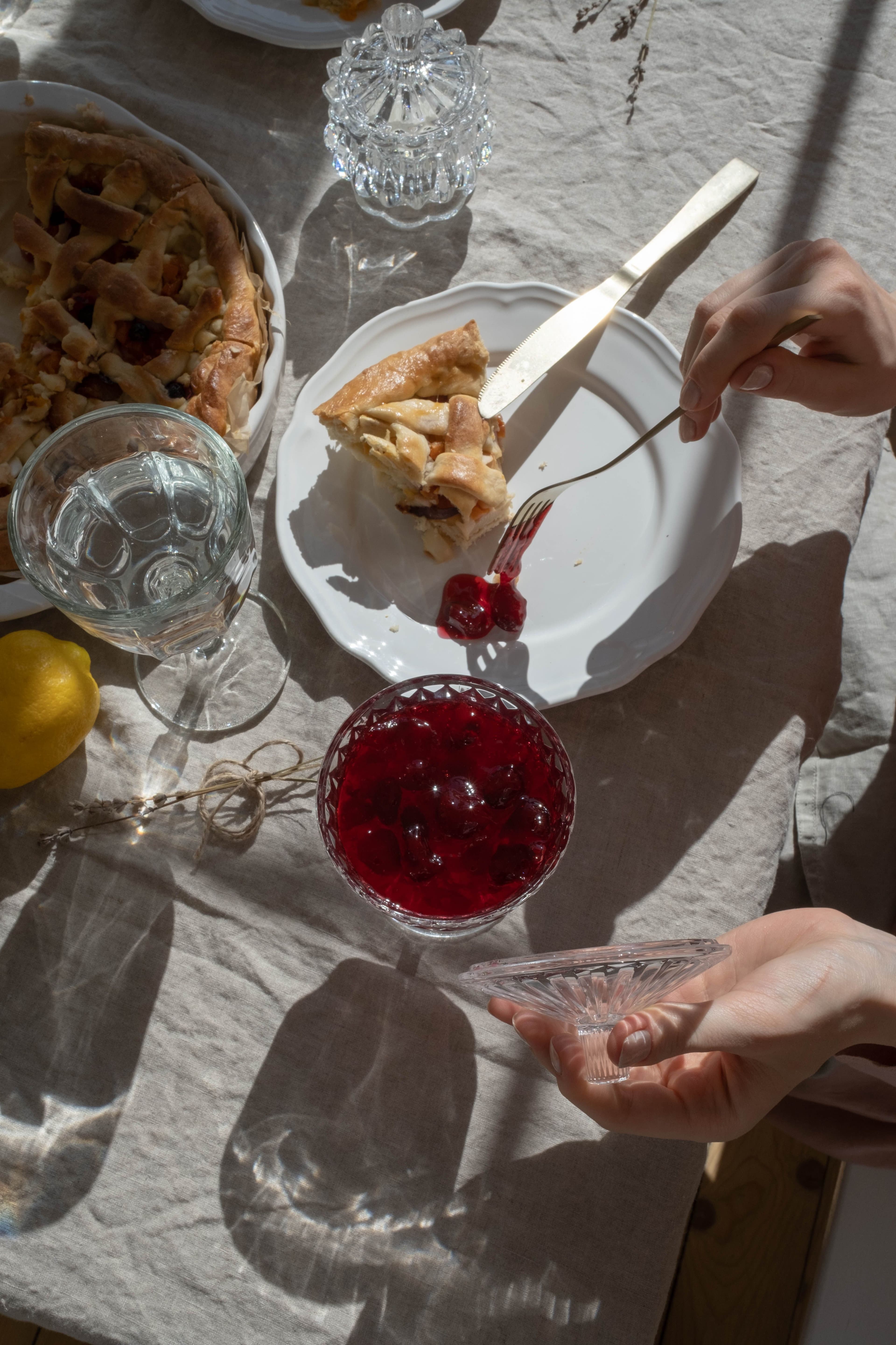 A table set with crystal water and wine glasses catching natural light