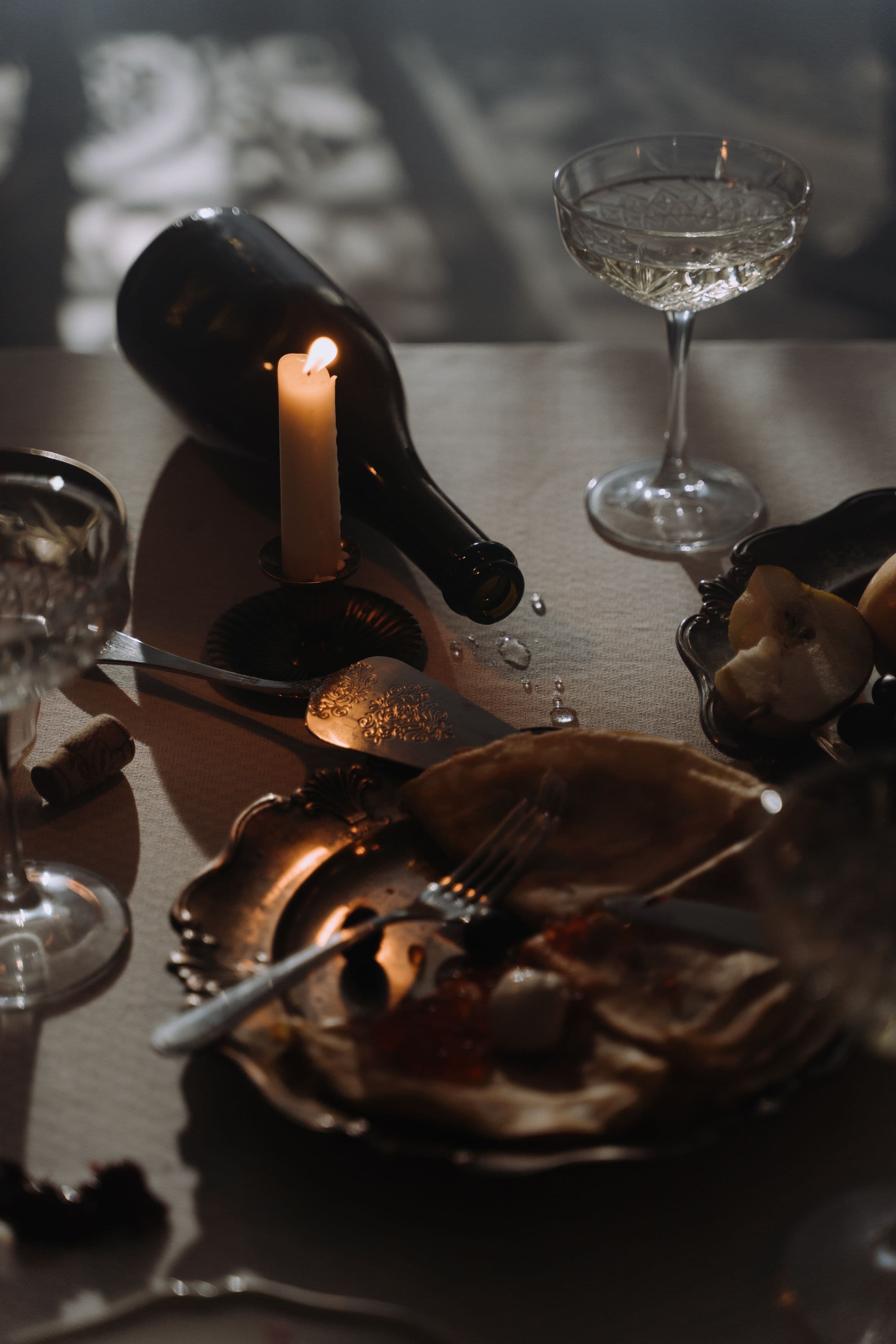 A hand turning a wine glass slowly by its stem