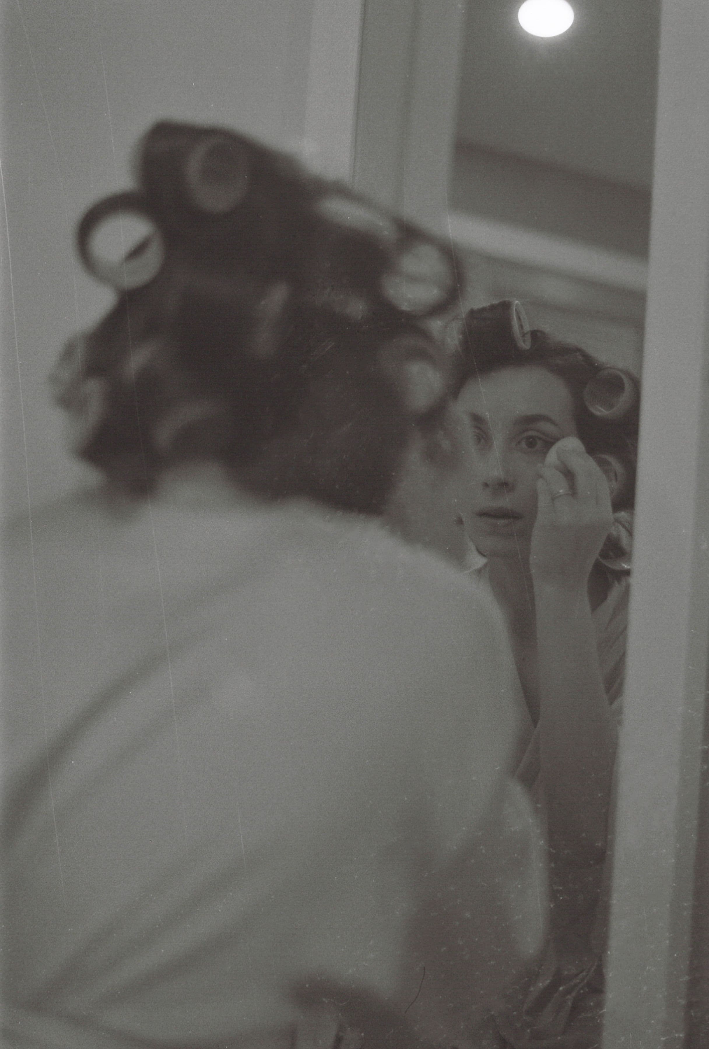 A woman with her hand through loose, voluminous hair